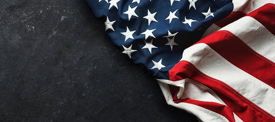 An American flag flaying on a black stone