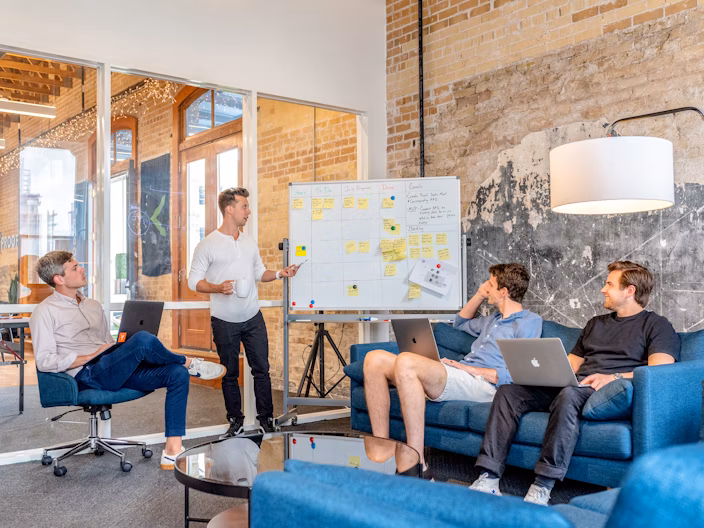 Four employees making business plans